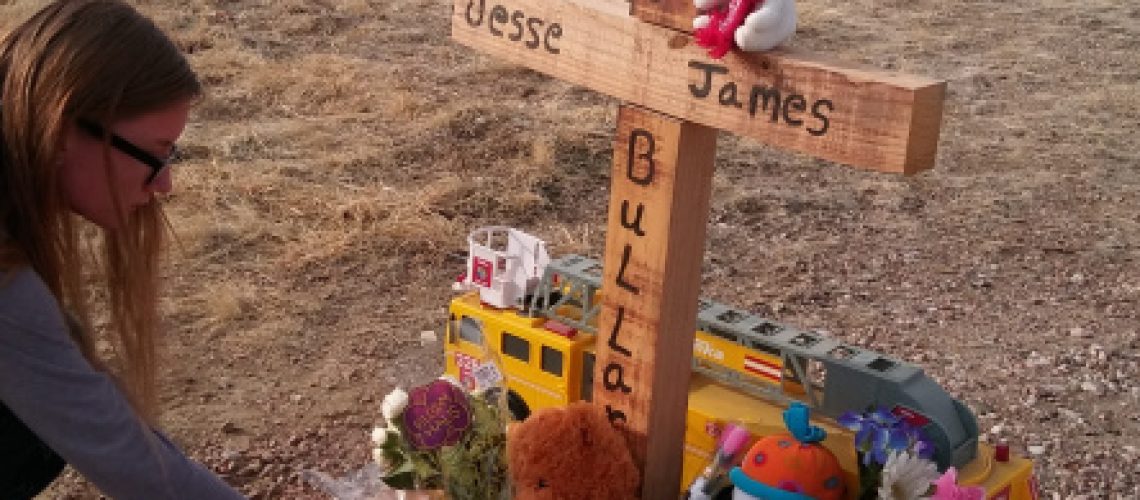 A neighbor leaves a stuffed bear at a memorial constructed for the toddler who was run over and killed by his father Wednesday. Carie Canterbury/Daily Record 1-24-20